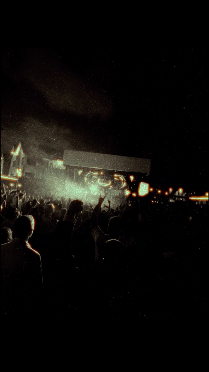 Dark concert crowd with stage lights