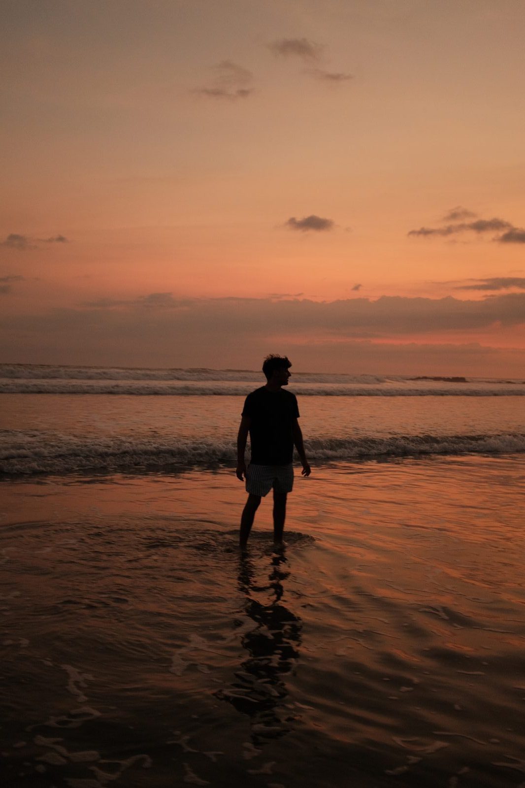 Silhouette figure at sunset on water