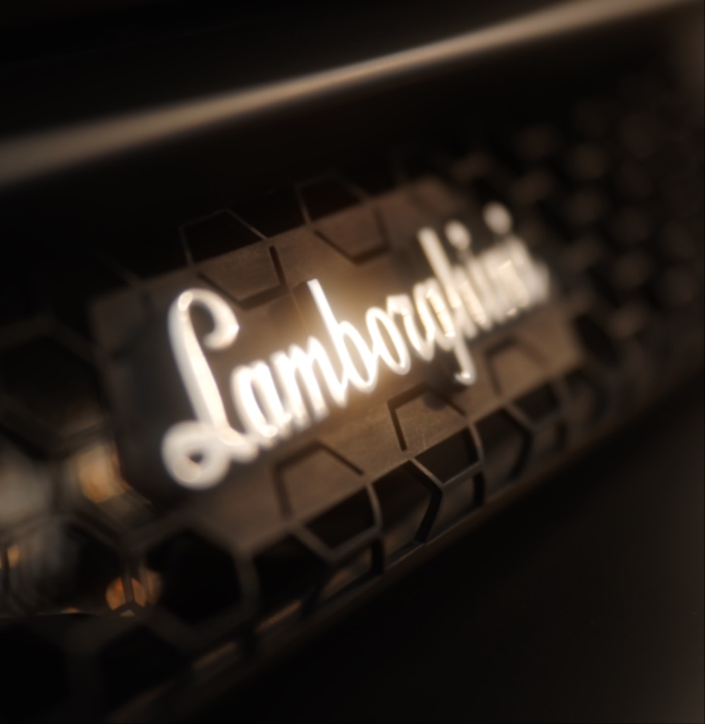 Lamborghini badge close-up with gold bokeh