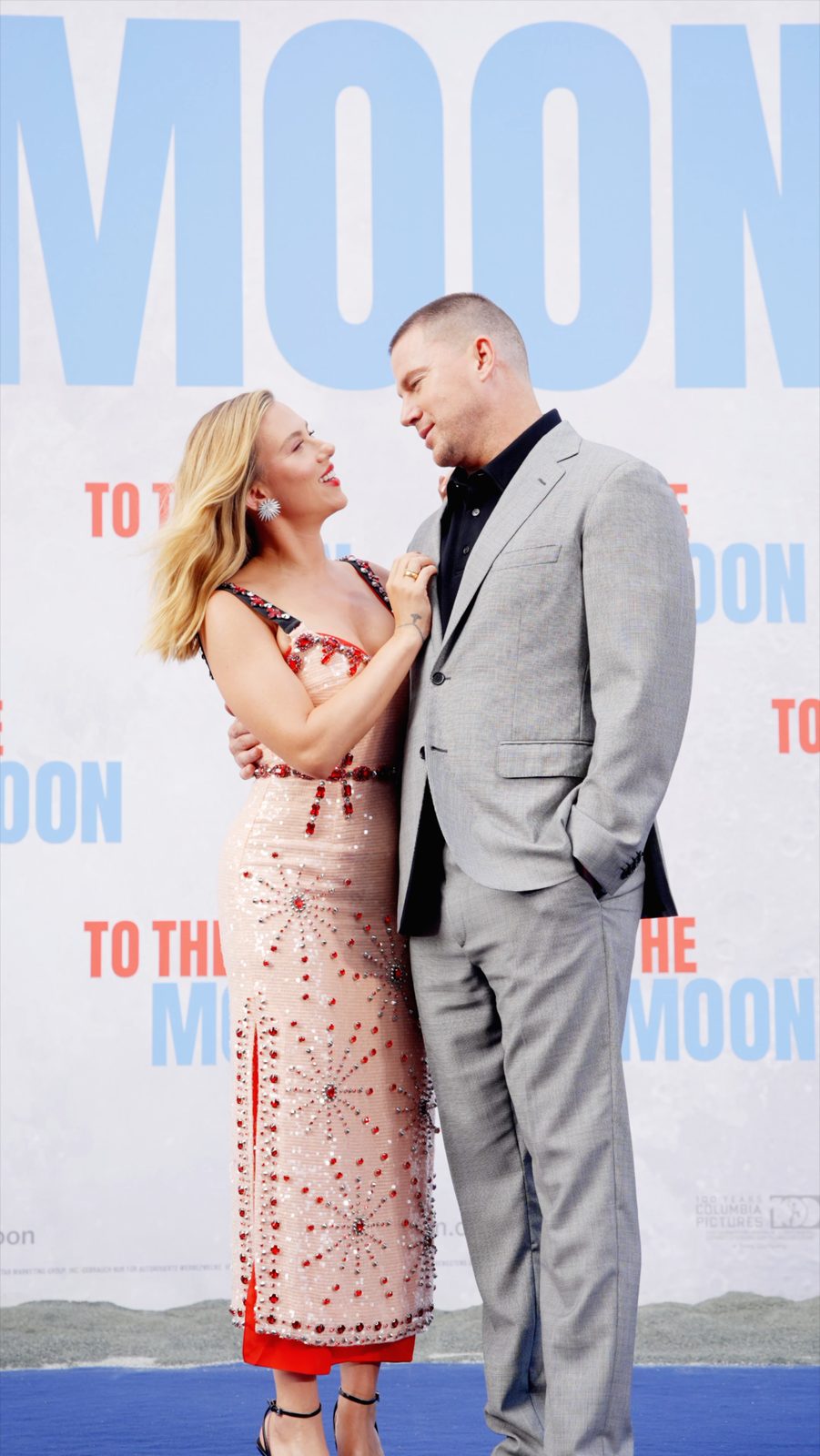 Red carpet couple portrait at media event