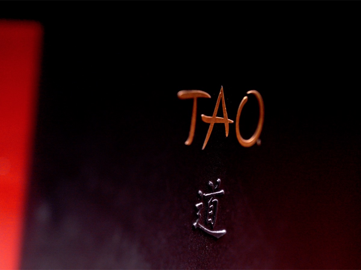 TAO restaurant branding in dark red and gold