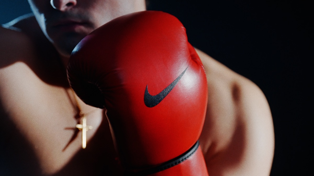 Nike boxing glove close-up with cross necklace